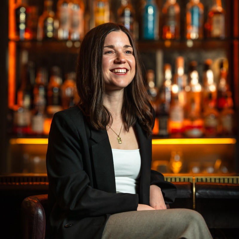 Lucy Brinton smiling in hospitality setting 