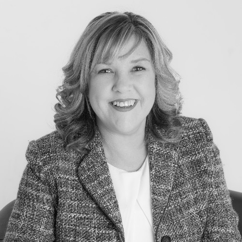 Black and white photo of Diana Celella smiling at the camera